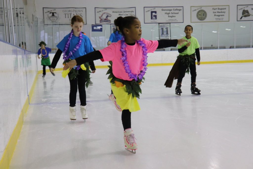 Kids on ice Kid skating on one leg arms out